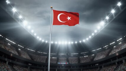 Turkish flag waving in packed stadium with bright lights