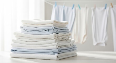 A stack of neatly folded white and blue towels on a white table with a white background.