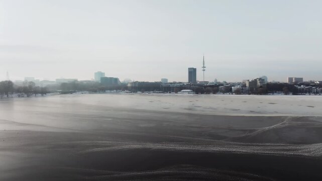 Aerial view of the wintery, frozen Outer Alster in Hamburg covered with heavy snow
