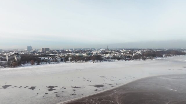 Aerial view of the wintery, frozen Outer Alster in Hamburg covered with heavy snow