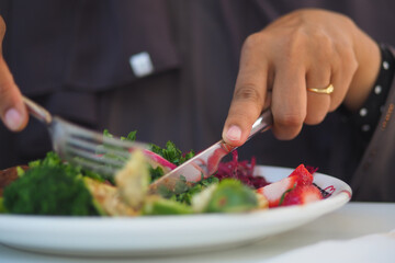 Eating a fresh salad at a local restaurant during lunch