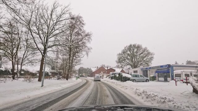 Footage of a wintery car drive on snow-covered roads in Hamburg and the surrounding area