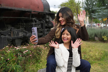 Mother and daughter having fun taking a selfie