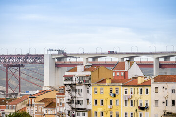 Bairro Alto apartment buildings below Lisbon bridge