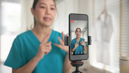 Young adult woman Gen Z asia people anti aging expert modern nurse live talk viral video selfie camera on mobile phone app mental health care. Online sharing digital virtual asian vlogger filming.