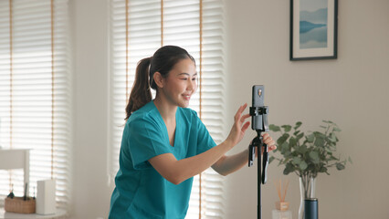 Young adult woman asia Gen Z people anti aging expert modern nurse live talk prepare video selfie camera on mobile phone app mental health care Online side hustle digital virtual asian vlogger filming