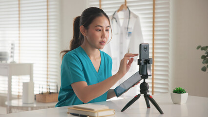 Young adult woman asia Gen Z people anti aging expert modern nurse live talk prepare video selfie camera on mobile phone app mental health care Online side hustle digital virtual asian vlogger filming