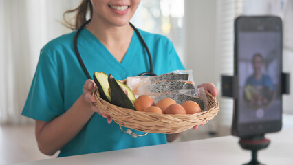 Asia woman people anti aging expert modern health care vlogger live advice talk selfie video mobile phone camera. Online diet food weight loss HDL meal plan recipe digital virtual asian coach filming.