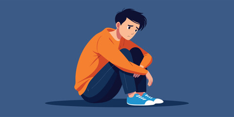 A young man in his late teens or early twenties with a concerned expression, sitting alone on a blue background, conveying a sense of sadness or worry.