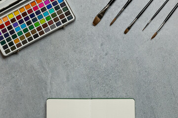 Artist Flat Lay with Watercolor Palette and Sketchbook