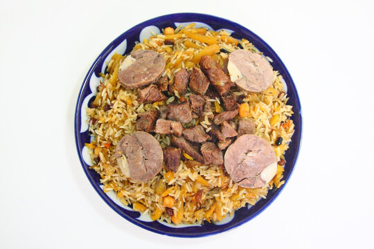 Traditional Uzbek pilaf with rice, beef, kazy
