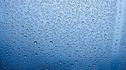 Water Droplets on Glass Window with Blue Background for Freshness and Nature Concepts