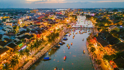 Dramatic aerial vista of the ancient town of Hoi An, Vietnam, illuminating at dusk. Highlighting...