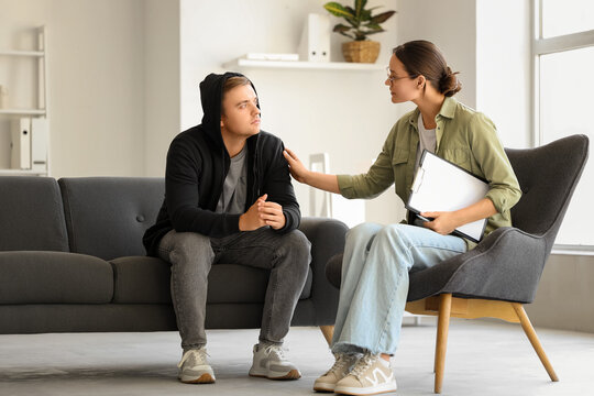 Female psychologist supporting man with suicidal thoughts in office