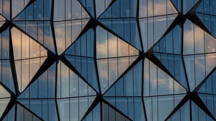Modern Glass Facade with Cloud Reflections