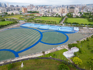 Aerial view of sports courts at Taichung Central Park, a modern urban oasis with the city skyline in the background. Taichung, Taiwan.

