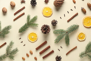 Composition with fir branches, spices, dried orange slices and pine cones on color background