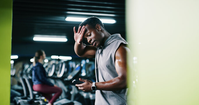 Man, sweating and scroll in gym with phone, workout break and notification for social media update. Space, exhausted person and tech with exercise website, internet and alert for fitness app tracker. - Powered by Adobe