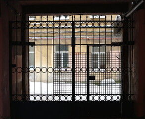 The lattice gate closes the entrance to the courtyard of the apartment building