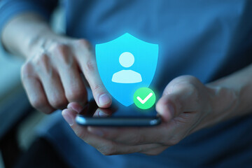 person holding smartphone with glowing blue shield and green checkmark icon for security and protection online high quality professional