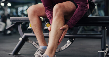 Fitness, hands and man on gym with calf pain, injury or accident for workout with inflammation. Osteoporosis, hurt and legs of male person in sports center with muscle bruise or joint sprain. © P2000/peopleimages.com