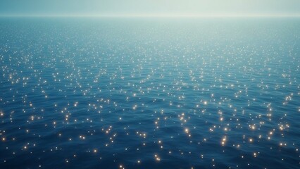 Calm ocean surface with sunlight reflecting on rippling water creating shimmering golden highlights on a serene blue sea