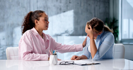 Female Therapist Providing Counseling Session For Hispanic Woman