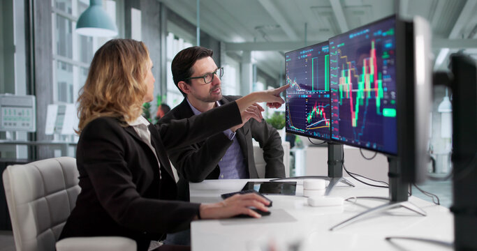 Male Financial Agent Trading On Multiple Screens