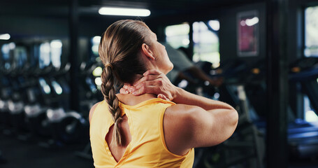 Back, woman and ache with neck pain at gym from fitness injury, muscle fatigue and inflammation....