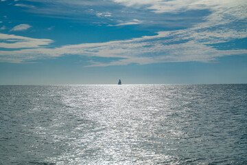 Obraz premium Sea with calm summer sky background. Sea smooth and bright. Sea calm with sunlight. Sea calm tranquil water.