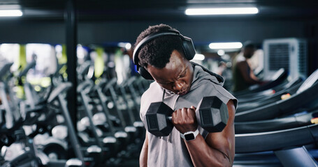 Exercise, headphones and weights with man in gym for bodybuilding, strength training or workout...