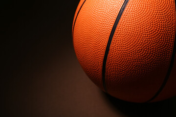 Ball for playing basketball game on dark background, closeup