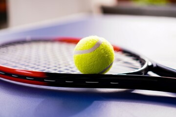 Tennis Ball Resting on Racket During Outdoor Practice