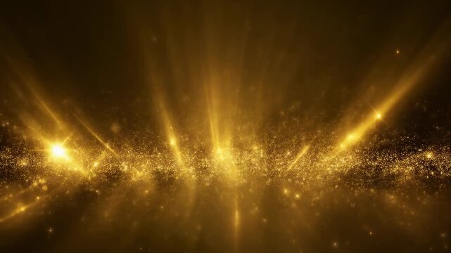 Golden light rays and sparkles on dark background.