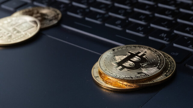 Closeup on Bitcoins Crypto currency on notebook 