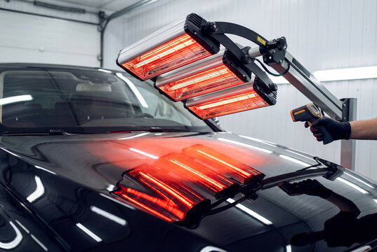 Infrared heating lamps used for curing paint or ceramic coating on a black car hood