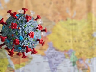 Model of coronavirus overlaid on a world map highlighting its global impact and spread during the pandemic