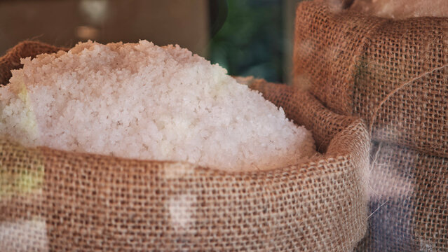 Coarse salt in sacks on the table.