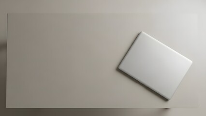 A blank white card is placed on a flat surface, casting a subtle shadow, captured from a directly overhead viewpoint.