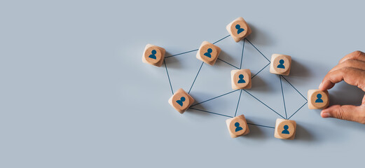 Organizational network structure with connected people icons on wooden blocks, showing team collaboration, stakeholder mapping, social graph, and business communication on a light background