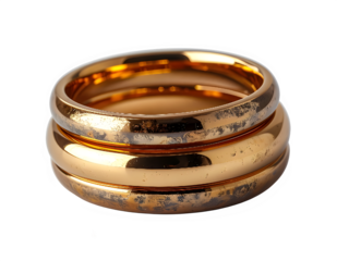 Close up gold wedding rings stacked together.