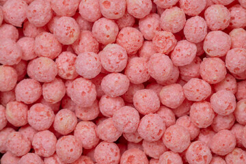Pink dry breakfast cereal as a texture, pattern, background	