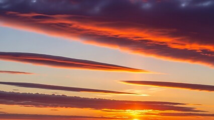 Colorful sunset sky with horizontal clouds and warm light