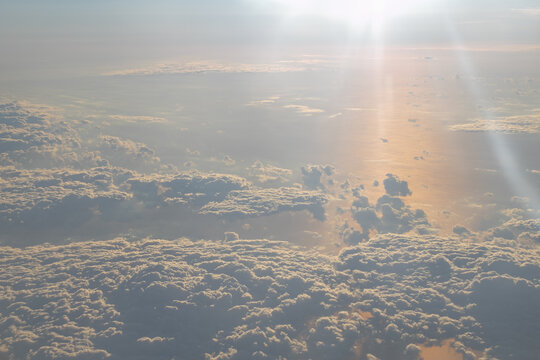 Aerial view of clouds illuminated by warm evening light