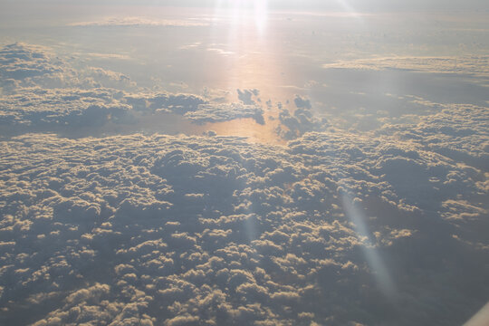 Sunlight rays over endless cloud layers viewed from above