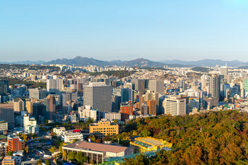 Naklejka premium Gold sun risae or sunset of Seoul cityscapes with high rise office buildings and skyscrapers in Seoul city, Republic of Korea in winter season