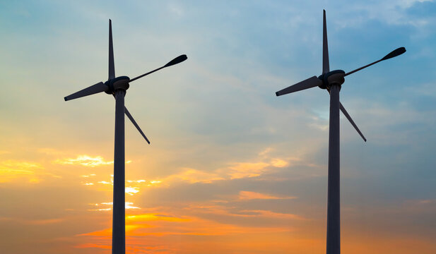 Wind mill power energy farm generator renewable sustainable field on suset, environment eco system technology industry ecology electricity power propeller turbine clean carbon.