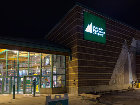 Calgary, Alberta, Canada. January 16, 2026. The exterior entrance of a Mountain Equipment Company retail store illuminated at night.