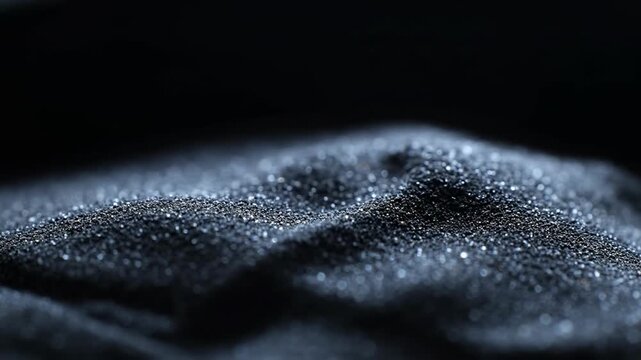 Extreme close-up of black sand with subtle texture variations