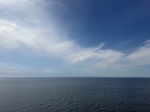 Beautiful sky clouds over calm ocean.